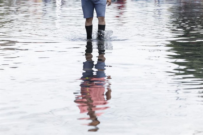 NEZAHUALCOYOTL, Aug. 13, 2025  -- A citizen wades through flood water in Nezahualcoyotl, a city 20 kilometers east of Mexico City center, Mexico, Aug. 12, 2025. Mexico City has experienced rare heavy rainfall in recent days, causing flood in the city and 