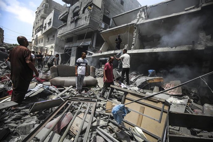 Palestinos examinan los escombros tras un ataque israelí en ciudad de Gaza