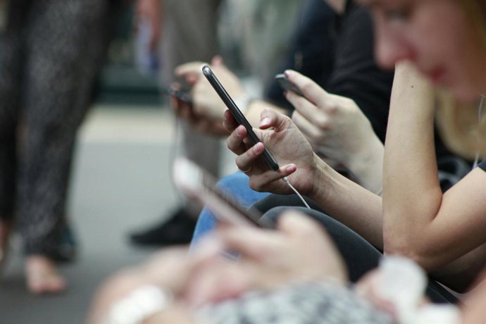 Mãos segurando um telefone celular