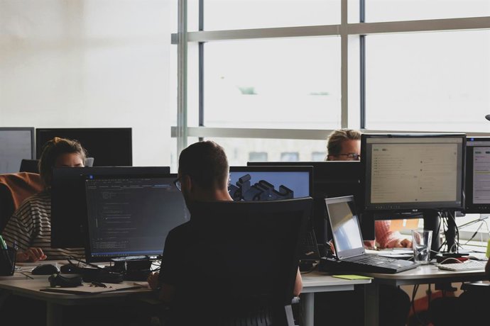 Recurso de empleados en la oficina trabajando delante del ordenador