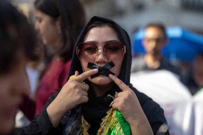 August 15, 2025, Madrid, Spain: A protester with black electrical tape covering her mouth takes part during a rally at Madrid's Puerta del Sol for Afghan women's rights. August 15 marks the fourth anniversary of the Taliban's capture of Kabul, an event th