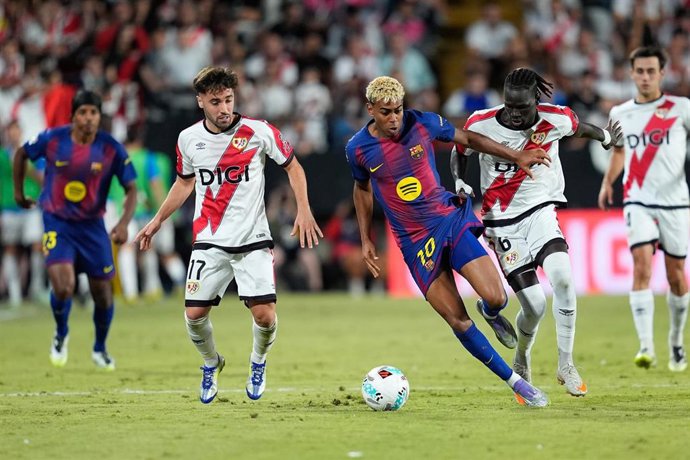 Lamine Yamal of FC Barcelona, Unai Lopez and Pathe Ciss of Rayo Vallecano compete for the ball during the Spanish League, LaLiga EA Sports, football match played between Rayo Vallecano and FC Barcelona at Estadio de Vallecas on August 31, 2025, in Madrid,