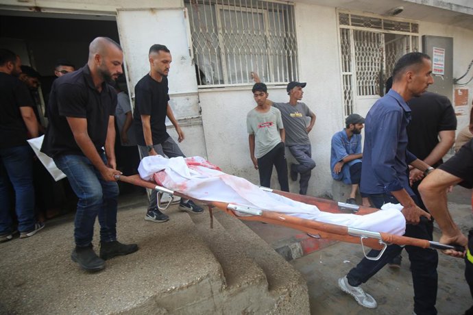 13 de agosto de 2025, Cidade de Gaza, Faixa de Gaza, Território Palestino: Parentes dos palestinos que morreram em decorrência dos ataques israelenses aos bairros de Zeytun e Shujaiya choram enquanto os corpos são levados do Hospital Al-Shifa para serem e