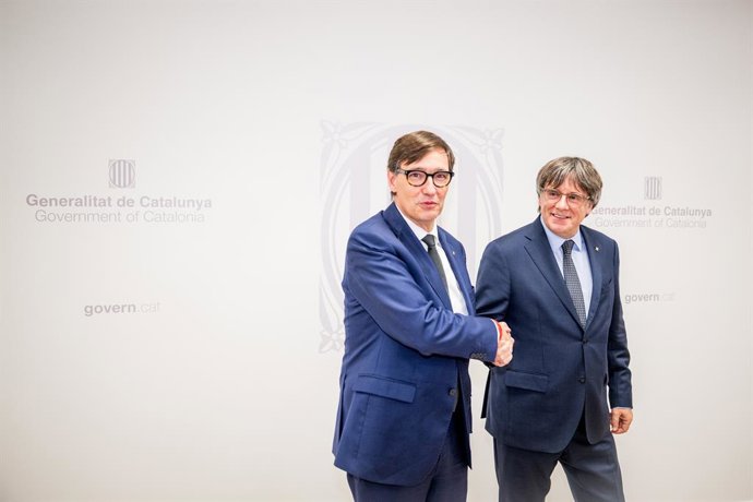 El presidente de la Generalitat, Salvador Illa (i), saluda al presidente de Junts per Catalunya, Carles Puigdemont (d), antes de una reunión, a 2 de agosto de 2025, en Bruselas (Bélgica). Illa, quién ha promovido la reunión, ha remarcado su intención de t