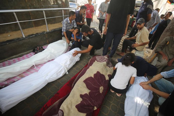 13 de agosto de 2025, Cidade de Gaza, Faixa de Gaza, Território Palestino: Parentes dos palestinos que morreram em decorrência dos ataques israelenses aos bairros de Zeytun e Shujaiya choram enquanto os corpos são levados do Hospital Al-Shifa para serem e