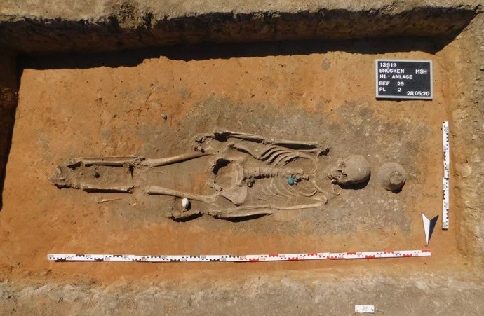 Entierro intacto de una mujer adulta con marcadores genéticos de origen local. Ajuar funerario: joyería de cuentas de vidrio y un amuleto de concha cauri. Cementerio preeslavo de Brücken, elemento 13913:29.
