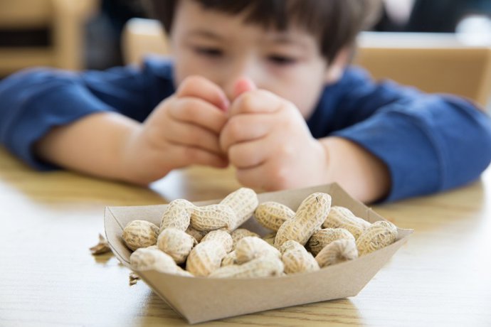 Archivo - Niño comiendo frutos secos. Alergia a alimentos.