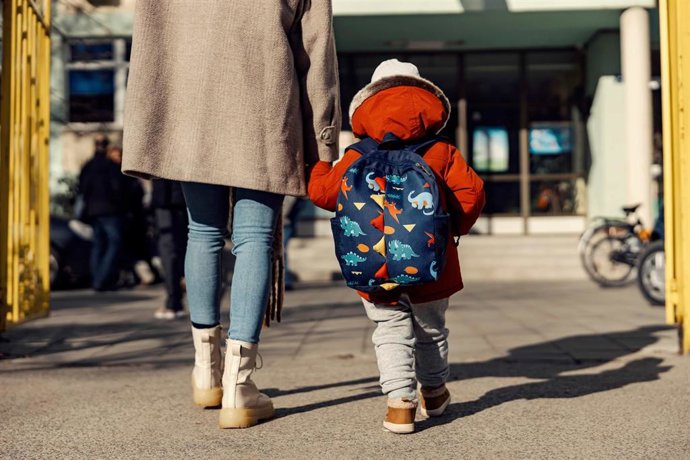 Imagen de archivo de un niño con mochila entrando al colegio.