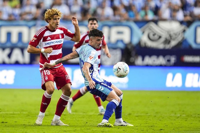Jorge Pascual of Granada CF and Diego Murillo of Malaga CF in action during the Spanish league, LaLiga Hypermotion, football match played between Malaga CF and Granada CF at La Rosaleda stadium on September 6, 2025, in Malaga, Spain.