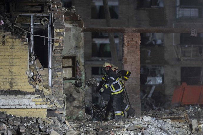 April 24, 2025, Kyiv, Kyiv City, Ukraine: As night falls in Kyiv, rescue services continue to work on site of impact after a Russian missile strike on Ukraine's capital Kyiv, hitting a residential area in the Sviatoshynskyi District. At least twelve peopl
