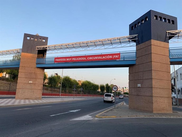 Una pasarela peatonal que cruza la travesía de La Puebla del Río.