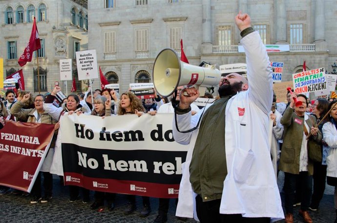 Archivo - Fotografía de archivo de personas protestan con pancartas y batas blancas durante una manifestación de Metges de Catalunya en huelga, a 26 de enero de 2023, en Barcelona