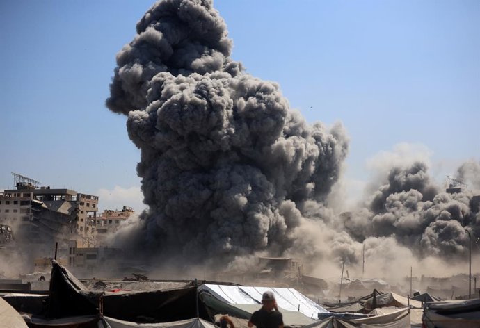 September 10, 2025, Gaza City, Gaza Strip, Palestinian Territory: Smoke billows near tents sheltering displaced Palestinians after Israeli bombardment destroys a building called Bab Al Bahr Tower in Gaza City's Rimal area on September 10, 2025. Israel's m