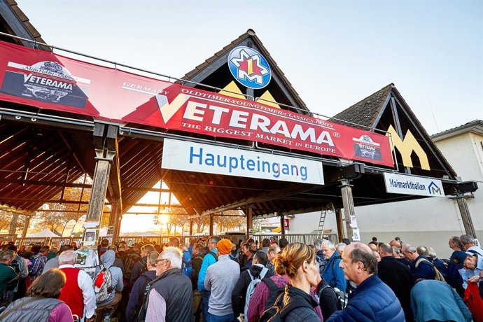 The photo shows the main entrance to VETERAMA at the Maimarkt grounds in Mannheim-Europe's largest classic car market. A long line of people has formed in front of the entrance.