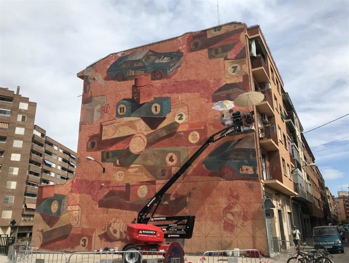 El muralista Remi Tournier realza su trabajo en la fachada de un edificio de la calle Eduardo Sanz Hernanz, en el distrito de San José
