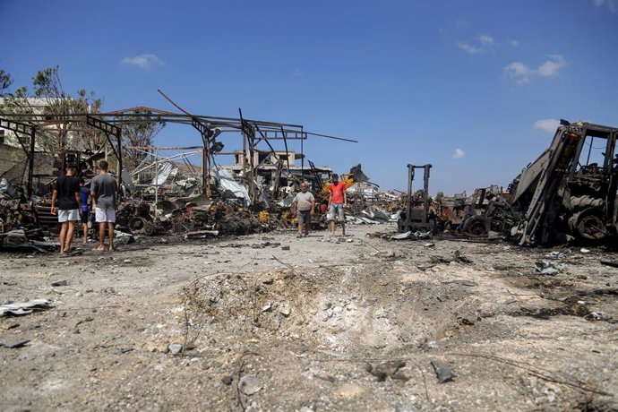 September 4, 2025, Ansarieh, Ansarieh, Lebanon: Lebanese walk near a crater caused by an Israeli rocket that destroyed heavy equipment in an overnight airstrike on an industrial complex in the Lebanese southern coastal town of Ansarieh. A string of overni
