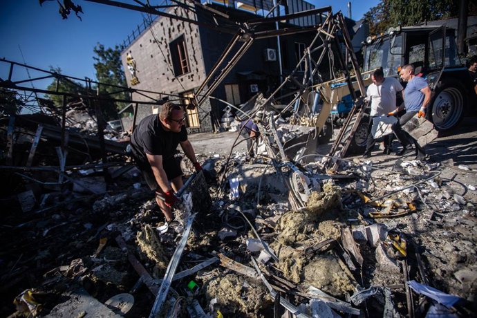September 12, 2025, Sumy, Sumy, Ukraine: A worker collects debris from a car repair shop attacked by Russian drones in the city of Sumy.