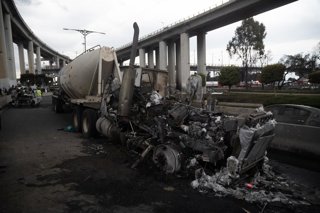 A truck burned is seen at the explosion scene occurred when a gas tanker overturned, causing the tragic accident that left 70 people have been injured, three dead, and two unidentified at Calzada Ignacio Zaragoza, near the Puente de la Concordia, . on Sep