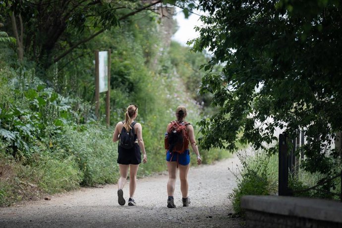 Archivo - Dos personas pasean por el Parc Natural de la Serra de Collserola, en una imagen de archivo.