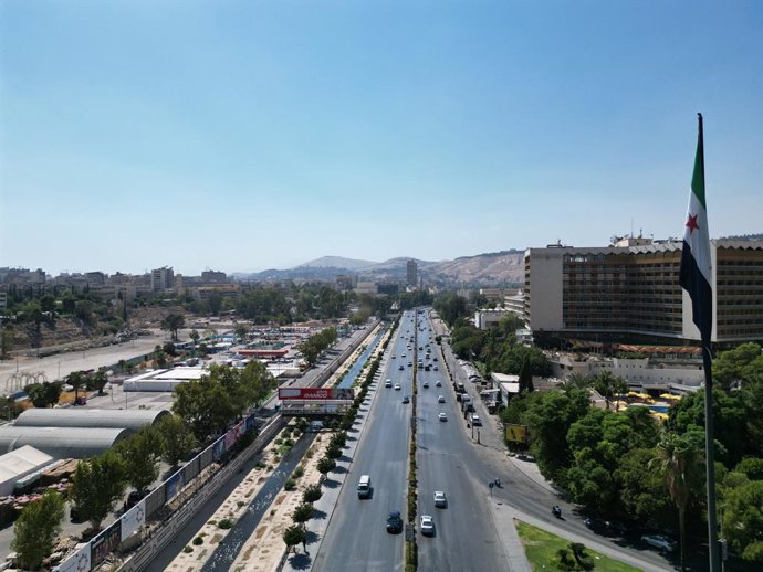 September 7, 2025, Damascus, Damascus, Syria: Aerial view shows the new Syrian national flag flying on a massive pole in the heart of Damascus, with Mount Qasioun, one of the cityâ€s most famous landmarks visible in the background.