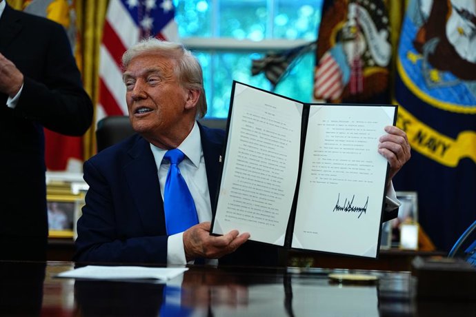 September 19, 2025, Washington, District Of Columbia, USA: United States President Donald J Trump holds a signed Executive Order authorizing the new Trump Gold Card, which is a visa program to be overseen by the Secretary of Commerce 'that will facilitate