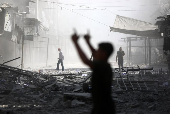 September 24, 2025, Gaza City, Gaza Strip, Palestinian Territory: Palestinians inspect the destruction after an Israeli airstrike hit Bank of Palestine in the Gaza Strip. The Bank of Palestine building was completely destroyed while other nearby structure