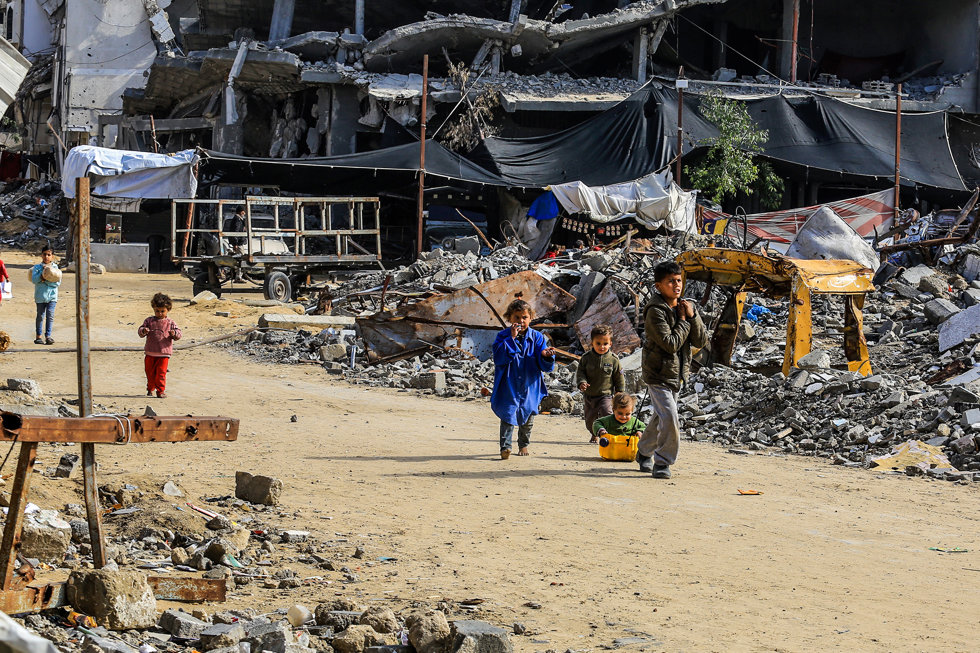 11 February 2025, Palestinian Territories, Khan Younis: Palestinian children play among the rubble and destruction in Khan Younis.