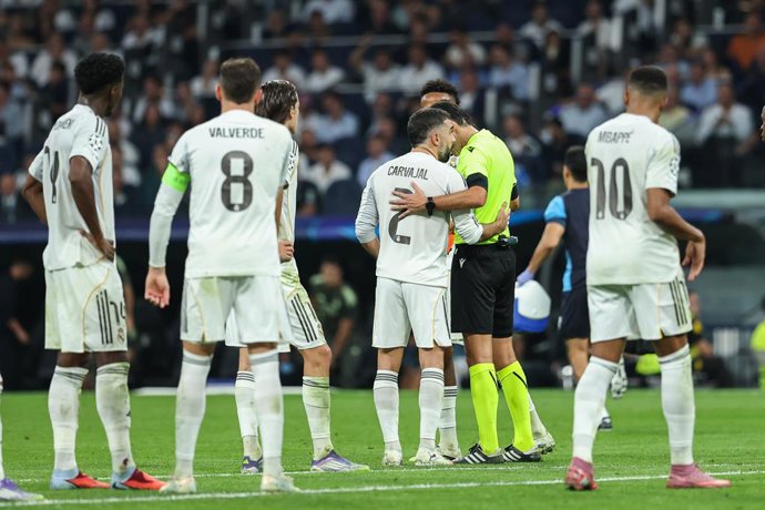 Daniel Carvajal of Real Madrid CF talking with Irfan Peljto, referee of the match, after receives the red car during the UEFA Champions League 2025/26 League Phase MD1 match between Real Madrid C.F. and Olympique de Marseille at Estadio Santiago Bernabeu 