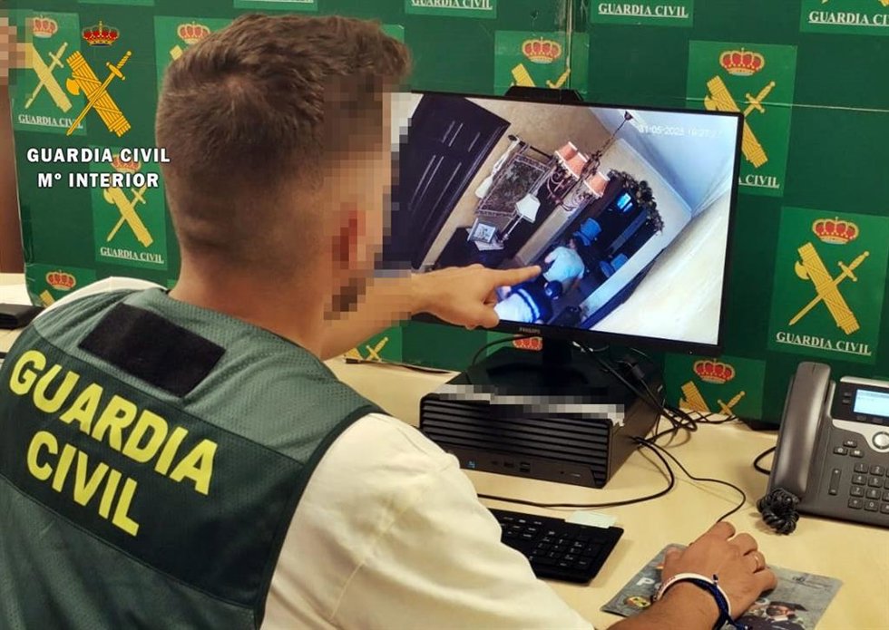 Un agente analiza imágenes de vídeo de uno de los robos atribuidos a la banda.