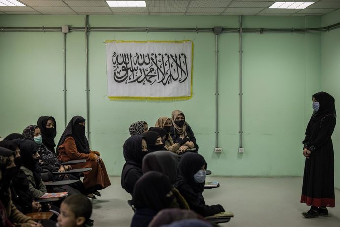 Archivo - Arxiu - Dones davant de la bandera talibà, a Kabul, Afganistan