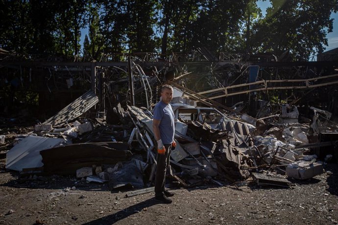 September 12, 2025, Sumy, Sumy, Ukraine: A worker stands among the remains of a car repair shop attacked by Russian drones in the city of Sumy.
