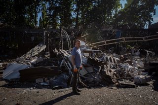 September 12, 2025, Sumy, Sumy, Ukraine: A worker stands among the remains of a car repair shop attacked by Russian drones in the city of Sumy.