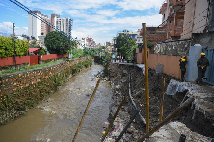 October 5, 2025, Kathmandu, Kathmandu, Nepal: Kathmandu Metropolitan City Police help reconstruct and clear debris from the Bafal riverside road in Kathmandu, Nepal, on October 5, 2025, which was damaged and blocked by floodwaters following continuous rai