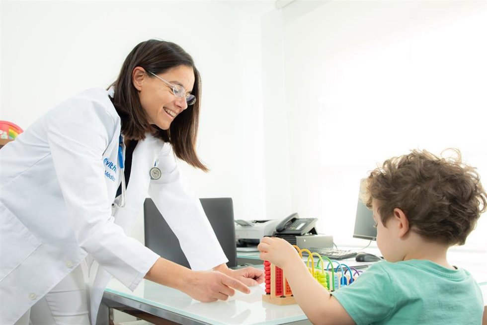 Archivo - Una doctora de Vithas junto a un niño