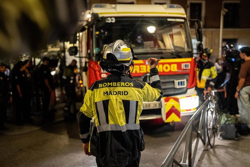 Varios bomberos de Madrid trabajan en las inmediaciones donde se ha derrumbado un edificio en obras, en la zona de Ópera