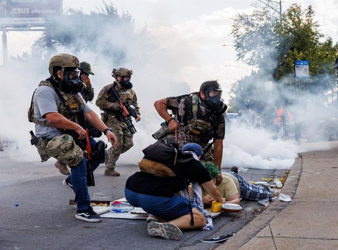 October 6, 2025: Federal officers detain a person while members of the community and activists protest near the 3900 block of South Kedzie Avenue on Oct. 4, 2025, in Chicago.