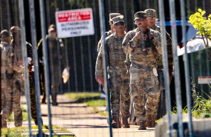October 9, 2025, Broadview, Illinois, USA: National Guard members walk around outside of the U.S. Immigration and Customs Enforcement holding facility in Broadview, Illinois, on Thursday, Oct. 9, 2025.
