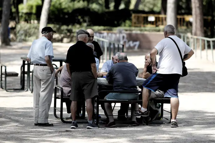 Pensionistas jugando al dominó en un parque de Madrid