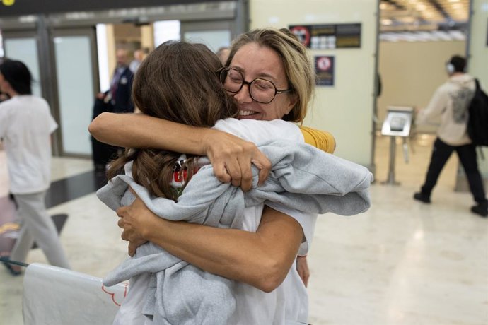 La activista Reyes Rigo abraza a una amiga a su llegada al aeropuerto Adolfo Suárez Madrid-Barajas, a 13 de octubre de 2025, en Madrid (España). Los seis últimos miembros de la flotilla retenidos por Israel, incluida la activista Reyes Rigo, llegan hoy lu