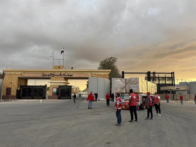 SHARM EL-SHEIKH, Oct. 12, 2025  -- Staff members from Egyptian Red Crescent stand near a truck carrying humanitarian aids as it enters Gaza from the Egyptian side of the Rafah border crossing on Oct. 12, 2025. Egyptian President Abdel Fattah al-Sisi said 