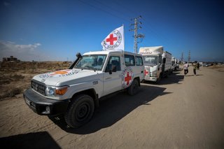 October 15, 2025, Dair El-Balah, Gaza Strip, Palestinian Territory: Members of the International Committee of the Red Cross (ICRC) wait near the Kisufim Border Gate in central Gaza to receive the bodies of around 60 Palestinians held by Israel, as part of