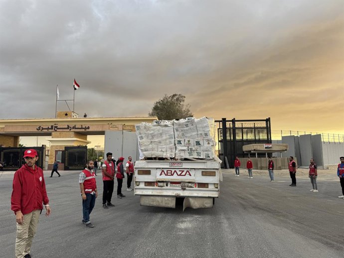 SHARM EL-SHEIKH, Oct. 12, 2025  -- Staff members from Egyptian Red Crescent stand near a truck carrying humanitarian aids as it enters Gaza from the Egyptian side of the Rafah border crossing on Oct. 12, 2025. Egyptian President Abdel Fattah al-Sisi said 