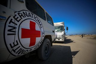 October 15, 2025, Dair El-Balah, Gaza Strip, Palestinian Territory: Members of the International Committee of the Red Cross (ICRC) wait near the Kisufim Border Gate in central Gaza to receive the bodies of around 60 Palestinians held by Israel, as part of