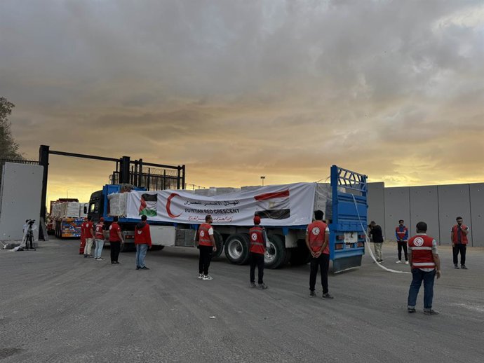 SHARM EL-SHEIKH, Oct. 12, 2025  -- Staff members from Egyptian Red Crescent stand near a truck carrying humanitarian aids as it enters Gaza from the Egyptian side of the Rafah border crossing on Oct. 12, 2025. Egyptian President Abdel Fattah al-Sisi said 
