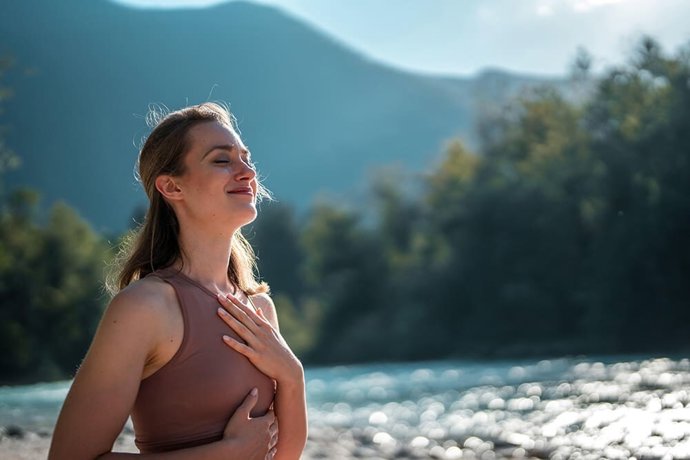 Young woman relaxing by the lake