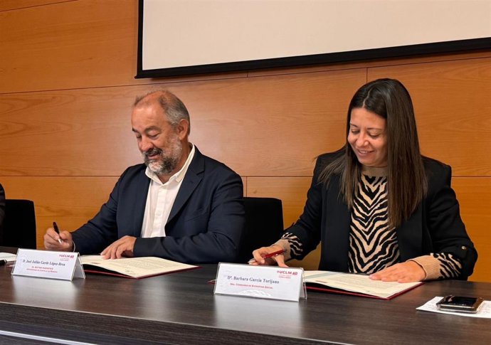 El rector de la UCLM, Julián Garde, y la consejera de Bienestar Social de C-LM, Bárbara García Torijano, firmando un convenio para iniciar un programa piloto de robótica aplicada a las personas dependientes.
