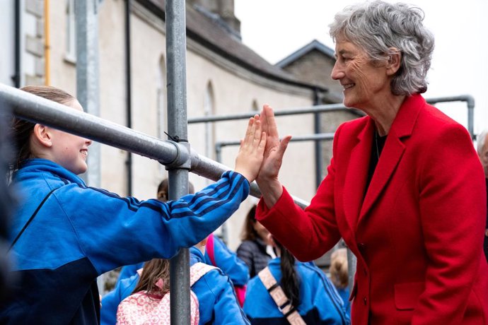 October 14, 2025, Naas, Kildare, IRELAND: 2025 Irish presidential candidate CATHERINE CONNOLLY (r) high fiving a young girl in Naas, County Kildare, Ireland on October 14, 2025. She has met locals on Poplar Square and then headed to Nas Na Riagh Housing A