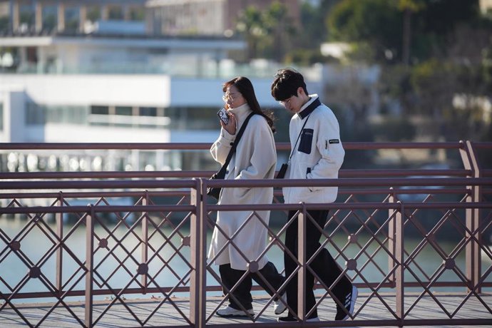 Archivo - Unos viandantes abrigados durante la ola de frío. A 14 de enero de 2025, en Sevilla (Andalucía, España). Descenso de las temperaturas con mínimas de 3 grados y máximas de 16 grados.