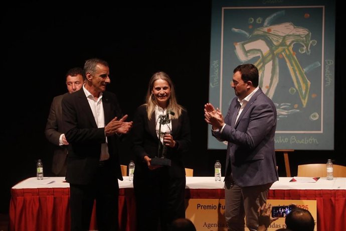 El presidente de Asturias, Adrián Barbón (dcha.), y el presidente de la Fundación Emilio Barbón,  José Vicente Barbón Fernández, entregan el galardón a la directora ejecutiva en España de UNRWA, Raquel Martí.
