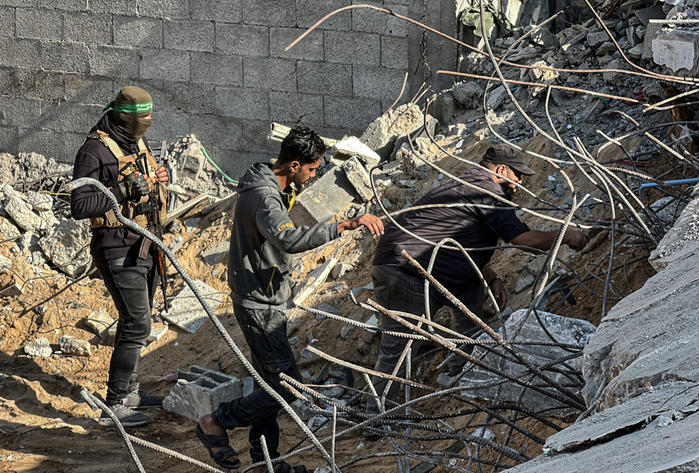 October 28, 2025, Nusairat, Gaza Strip, Palestinian Territory: Egyptian Committee teams and members of Hamas military wing, al-Qassam Brigades take part in the search operations for the remains of Israeli hostages in the area where Israel carried out 